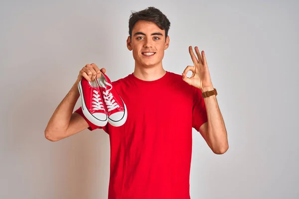 Teenager Boy Holding Fashion Casual Sneakers Red Isolated Background Doing — ストック写真