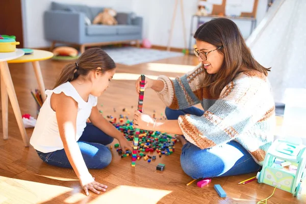 Красивий Вчитель Малюк Грають Будівельними Блоками Іграшки Навколо Безлічі Іграшок — стокове фото