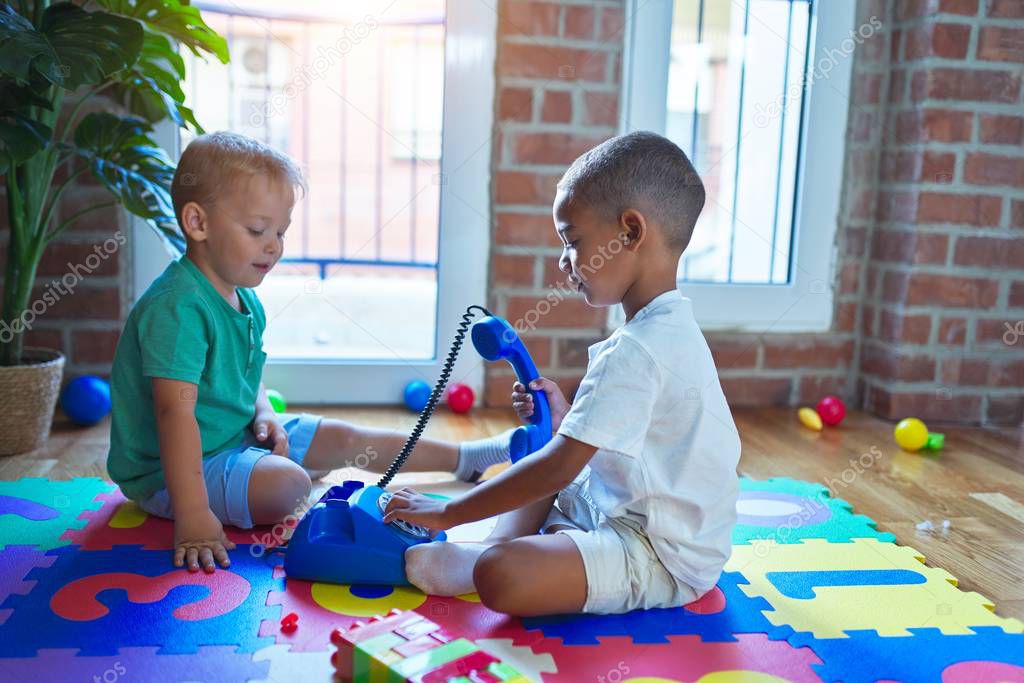 Adorable toddlers playing around lots of toys at kindergarten