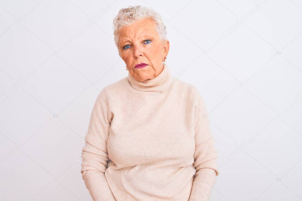 Senior grey-haired woman wearing turtleneck sweater standing over isolated white background looking sleepy and tired, exhausted for fatigue and hangover, lazy eyes in the morning.