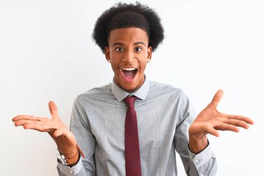 Genç afro-Amerikan işadamı izole beyaz arka plan üzerinde duran kravat giyen deli kutluyor ve silah kaldırdı ve açık gözleri heyecan çığlık ile başarı için hayran. Kazanan kavramı