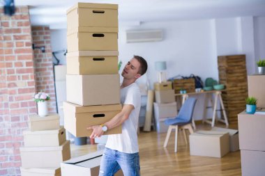 man carrying many boxes