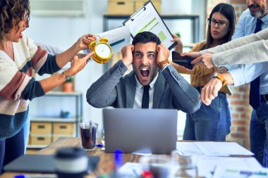 Group of business workers working together. Partners stressing one of them at the office