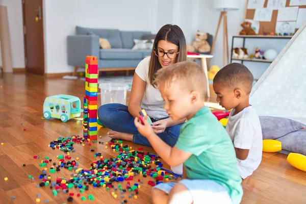 Joven Hermosa Maestra Niños Pequeños Jugando Con Bloques Construcción Alrededor —  Fotos de Stock