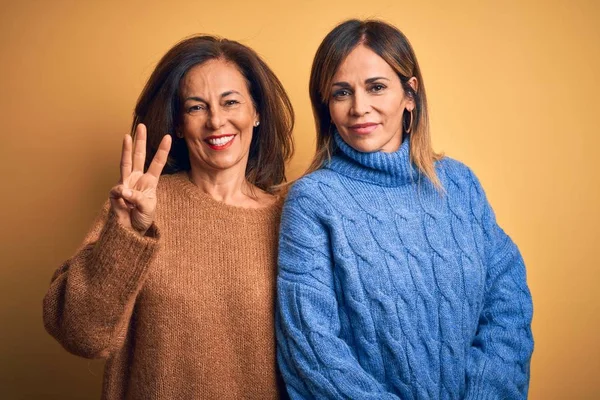 Middle Age Beautiful Couple Sisters Wearing Casual Sweater Isolated Yellow — 스톡 사진