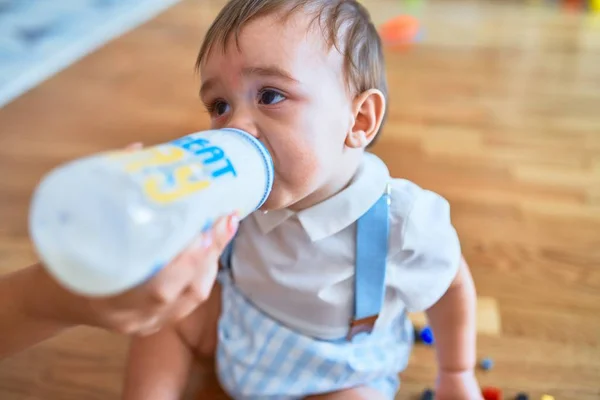 Adorable Toddler Sitting Floor Drinking Milk Using Feeding Bottle Kindergarten — Stock Photo, Image