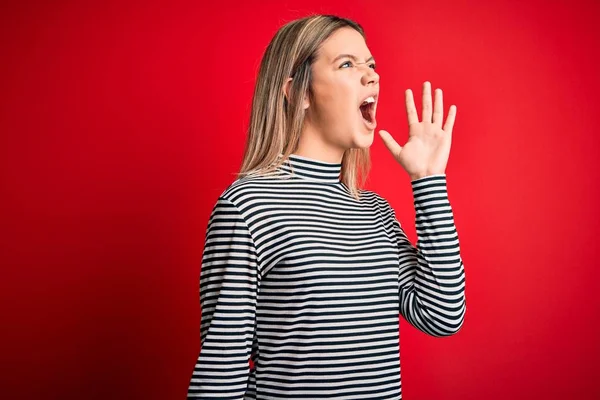 Young Beautiful Blonde Woman Wearing Casual Striped Sweater Red Isolated — ストック写真