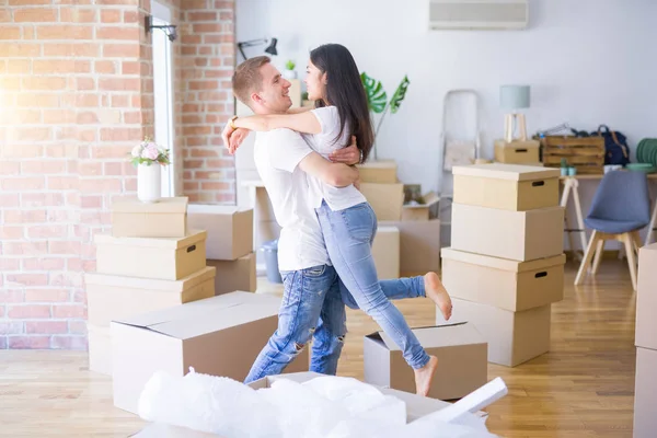 Young Beautiful Couple Hugging New Home Cardboard Boxes — Stock Photo, Image