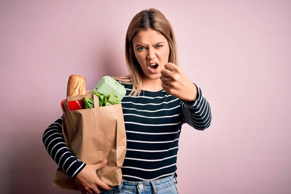 Young Beautiful Woman Holding Paper Bag Purchase Isolated Pink Background — Stock Photo, Image