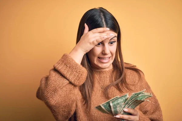 Young Beautiful Woman Holding Dollars Standing Isolated Orange Background Stressed — 스톡 사진