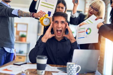 Group of business workers working together. Partners stressing one of them at the office