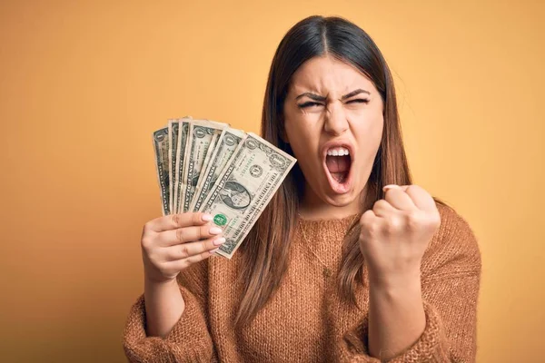 Joven Hermosa Mujer Sosteniendo Dólares Pie Sobre Fondo Naranja Aislado — Foto de Stock