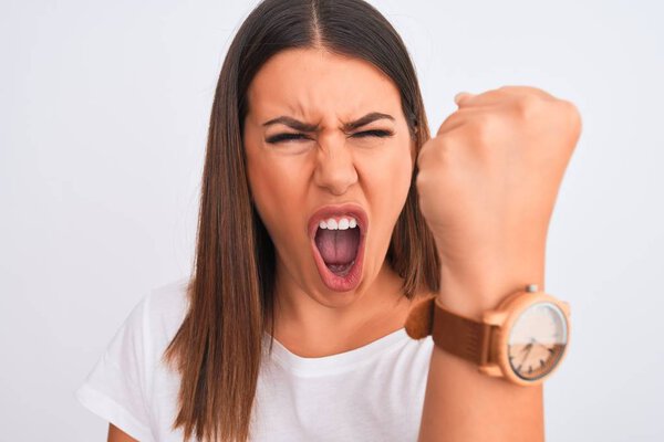 Close up of beautiful and young brunette woman standing over isolated white background annoyed and frustrated shouting with anger, crazy and yelling with raised hand, anger concept