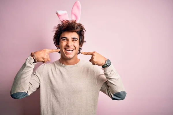 Young Handsome Man Holding Easter Rabbit Ears Standing Isolated Pink — Stockfoto