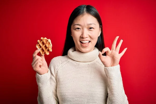 Young Asian Woman Eating Sweet Tasty Belgian Waffle Red Isolated — Stok fotoğraf