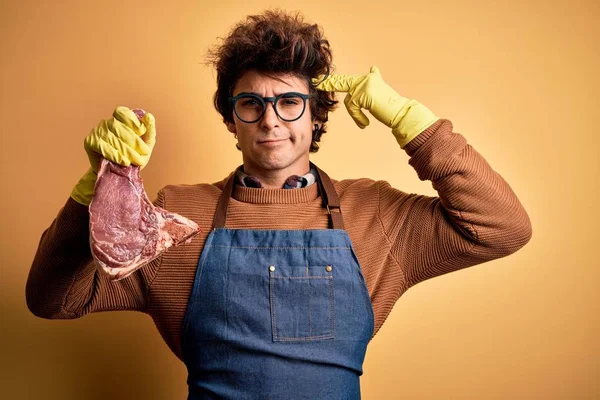 Young Handsome Butcher Man Holding Meet Steak Standing Isolated Yellow — Stockfoto