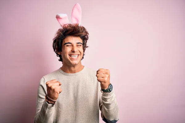 Young Handsome Man Holding Easter Rabbit Ears Standing Isolated Pink — Stockfoto