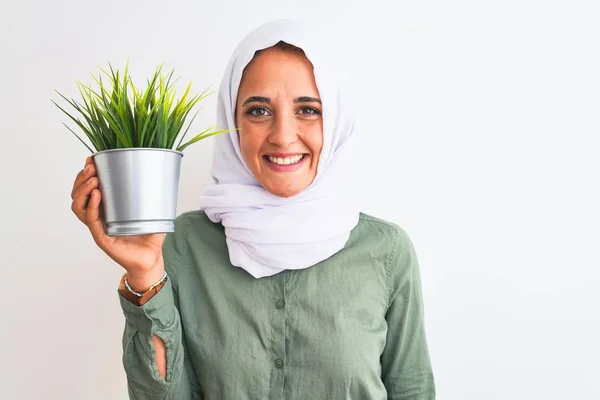 Young Arab Woman Wearing Hijab Holding Plant Pot Isolated Background — Stok fotoğraf