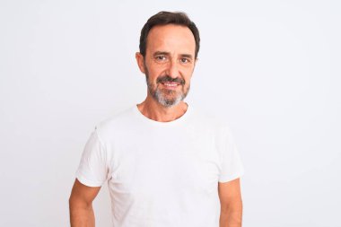 Middle age handsome man wearing casual t-shirt standing over isolated white background Relaxed with serious expression on face. Simple and natural looking at the camera.