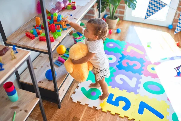 Adorable Toddler Holding Duck Doll Standing Lots Toys Kindergarten — Stock Photo, Image