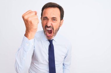 Middle age businessman wearing elegant tie standing over isolated white background angry and mad raising fist frustrated and furious while shouting with anger. Rage and aggressive concept.