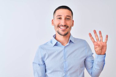 Young handsome business man standing over isolated background showing and pointing up with fingers number four while smiling confident and happy.