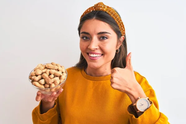 Young Beautiful Woman Holding Bowl Peanuts Standing Isolated White Background — 图库照片