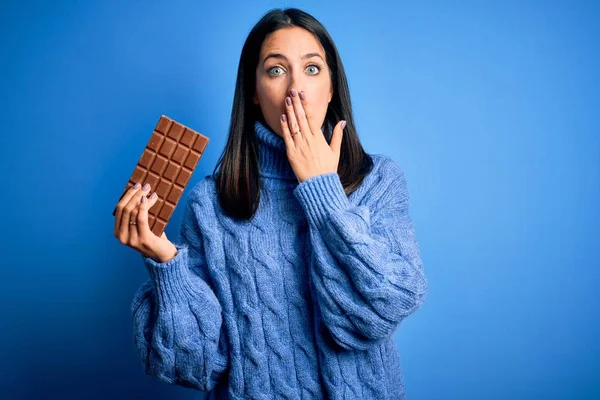 Young Woman Blue Eyes Holding Sweet Chocolate Bar Standing Isolated — Stok fotoğraf