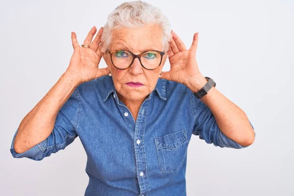 Starsza Siwowłosa Kobieta Dżinsowej Koszuli Okularach Białym Tle Próbująca Usłyszeć — Zdjęcie stockowe