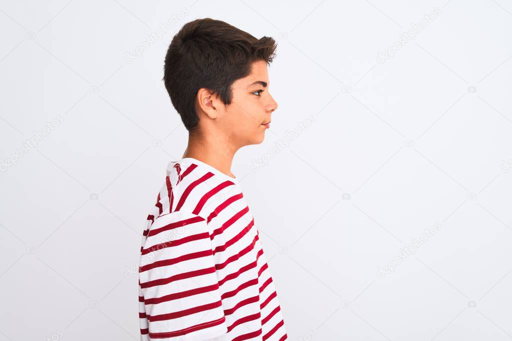 Handsome teenager boy standing over white isolated background looking to side, relax profile pose with natural face with confident smile.