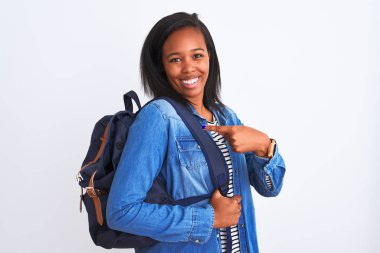 Young african american student woman wearing backpack over isolated background very happy pointing with hand and finger