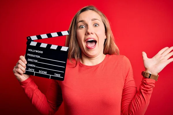 Ung Vacker Blond Clapper Kvinna Håller Clapboard Över Isolerad Röd — Stockfoto