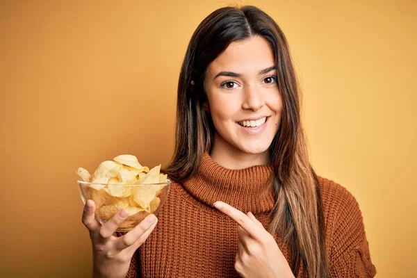 Young Beautiful Girl Holding Bowl Chips Potatoes Standing Yellow Background — Stock Photo, Image