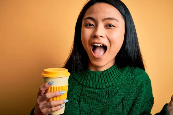Young Beautiful Chinese Woman Drinking Cup Coffee Isolated Yellow Background — 스톡 사진