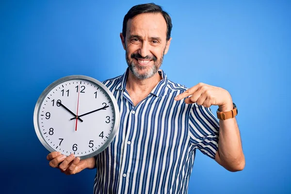 Middle Age Hoary Man Holding Big Clock Standing Isolated Blue — 스톡 사진