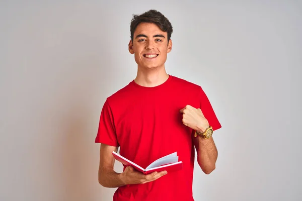 Teenager Student Boy Reading Book Isolated Background Surprise Face Pointing — ストック写真