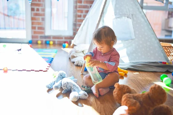 Adorable Toddler Holding Feeding Bottle Lots Toys Kindergarten — Stock Photo, Image