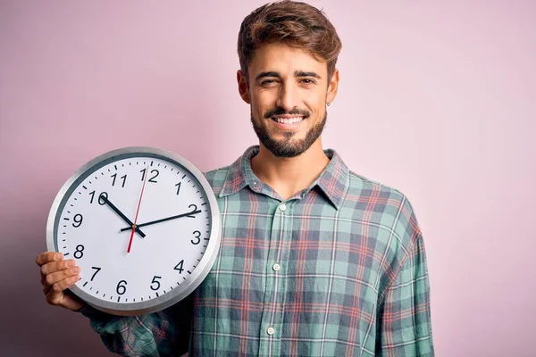 Young Man Beard Doing Countdown Using Big Clock Isolated Pink — 스톡 사진