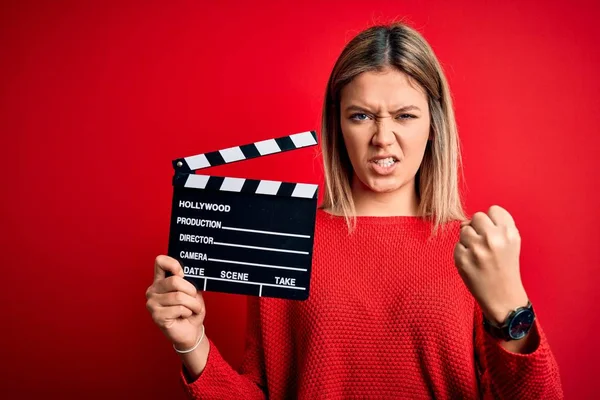 Young Beautiful Woman Holding Clapboard Standing Isolated Red Background Annoyed — Stok fotoğraf