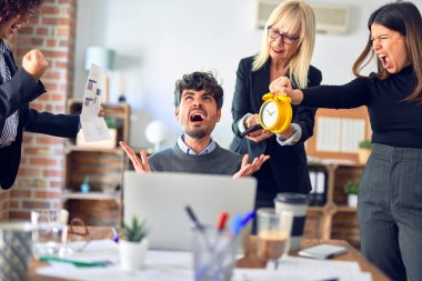 Group of business workers working together. Partners stressing one of them at the office