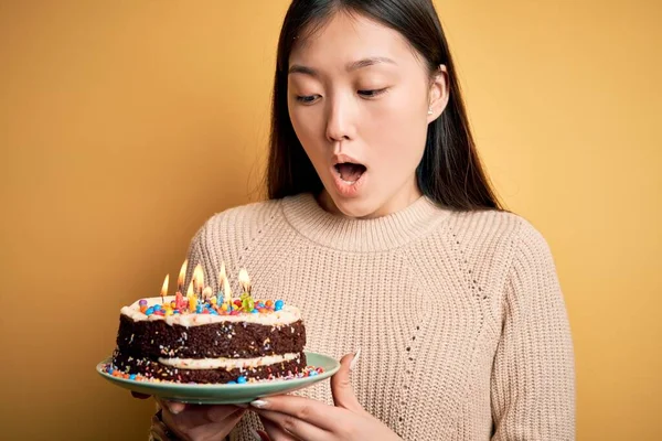 Junge Asiatische Frau Hält Geburtstagstorte Mit Brennenden Kerzen Auf Gelbem — Stockfoto