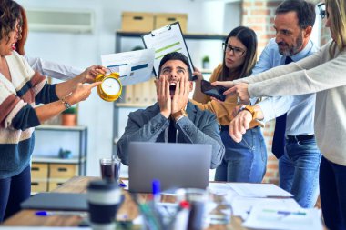 Group of business workers working together. Partners stressing one of them at the office