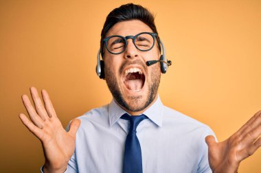 Çağrı merkezinden gelen müşteri hizmetleri kulaklığı takan genç bir işletmeci başarının çılgınlığını kollarını kaldırıp heyecanla haykırarak kutluyor. Kazanan konsept