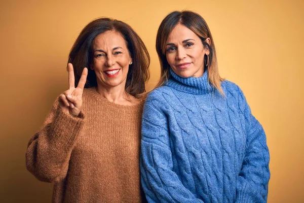 Middle Age Beautiful Couple Sisters Wearing Casual Sweater Isolated Yellow — Stok fotoğraf