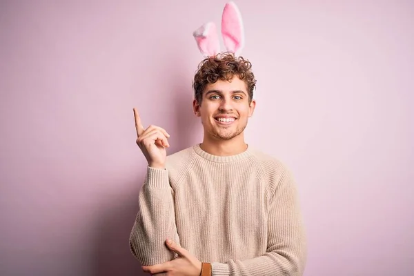 Young Handsome Blond Man Wearing Easter Rabbit Ears Isolated Pink — Stockfoto