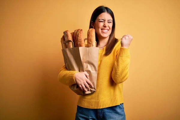 Young Beautiful Woman Holding Bag Fresh Healthy Bread Yellow Background — 스톡 사진