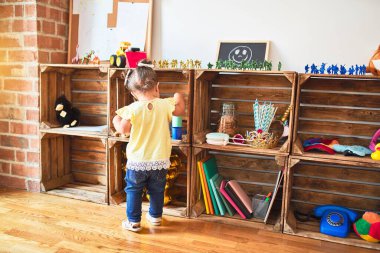 Anaokulunda renkli plastik bardaklarla oynayan güzel çocuk.