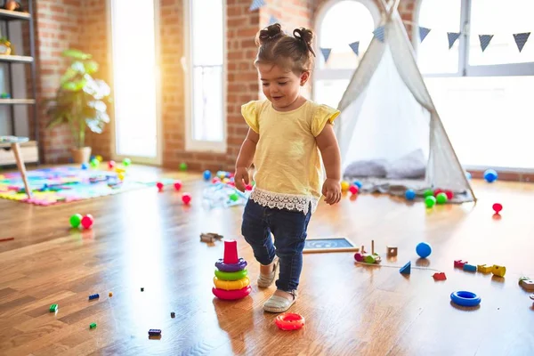 Schönes Kleinkind Baut Pyramide Mit Plastikreifen Kindergarten — Stockfoto