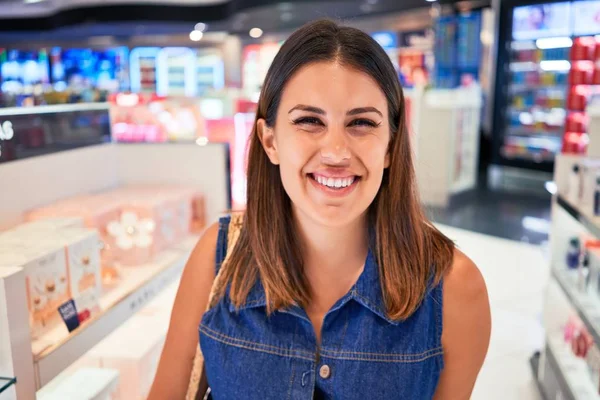 Young traveller woman at the tax free shop at the airport