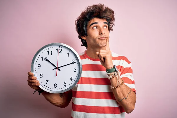 Young Handsome Man Holding Big Clock Standing Isolated Pink Background — Stok fotoğraf
